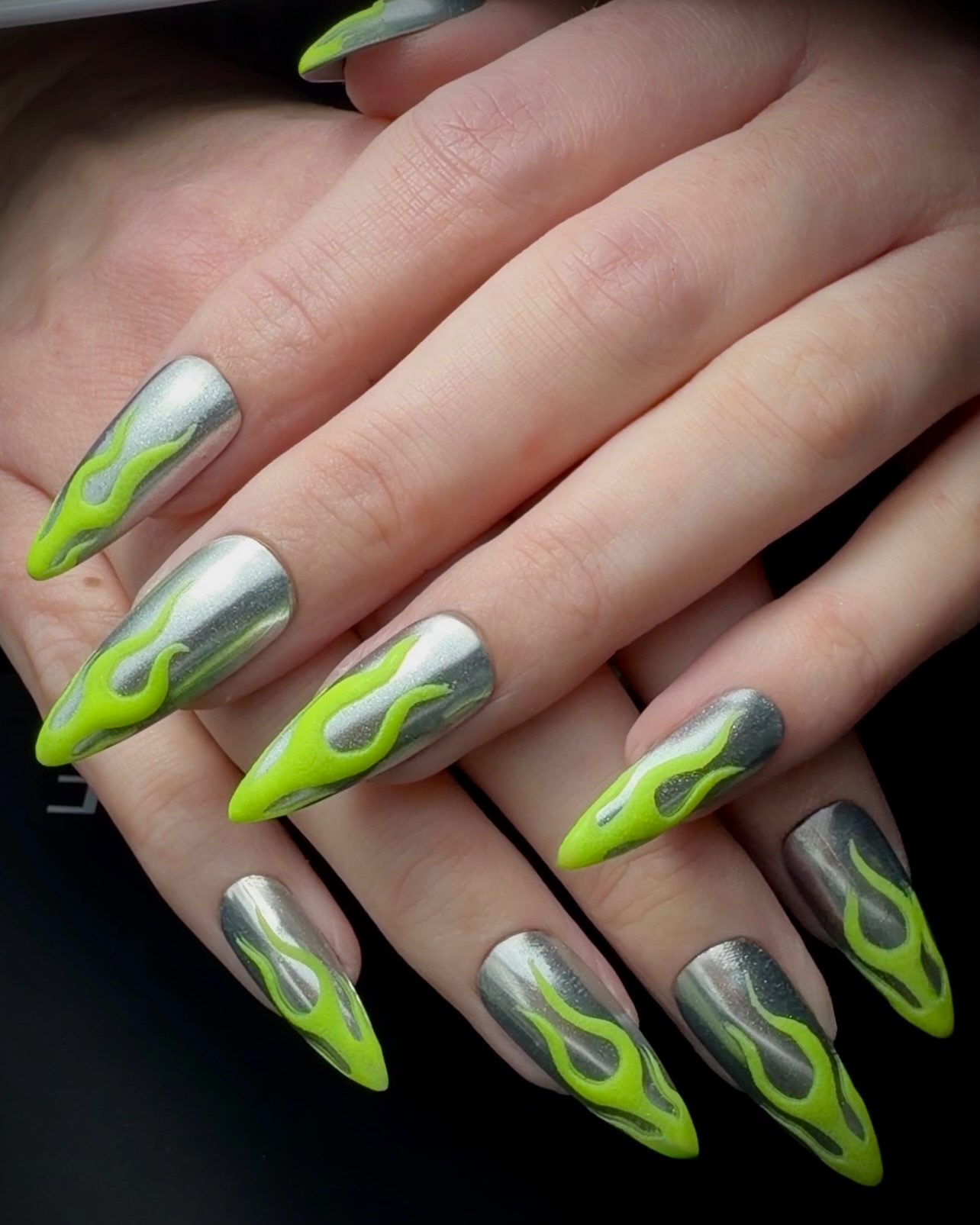 silver chrome long stiletto nails with neon green flame details